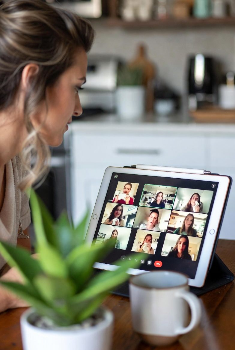 A client at her kitchen table joining an AES group session on her tablet